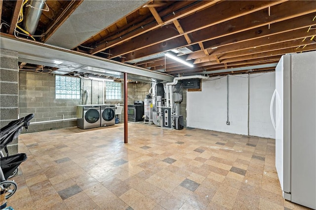 225 Larson Blvd, Rostraver, PA 15012 - basement featuring freestanding refrigerator, washing machine and dryer, a sink, tile patterned floors, and heating unit