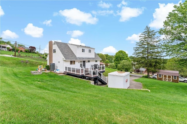 225 Larson Blvd, Rostraver, PA 15012 - rear view of property with central AC unit, a wooden deck, a lawn, and a chimney
