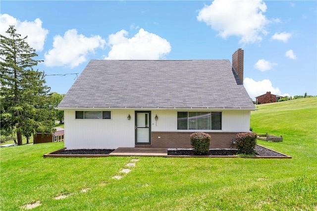 225 Larson Blvd, Rostraver, PA 15012 - view of front facade with a chimney, a front lawn, brick siding, and roof with shingles