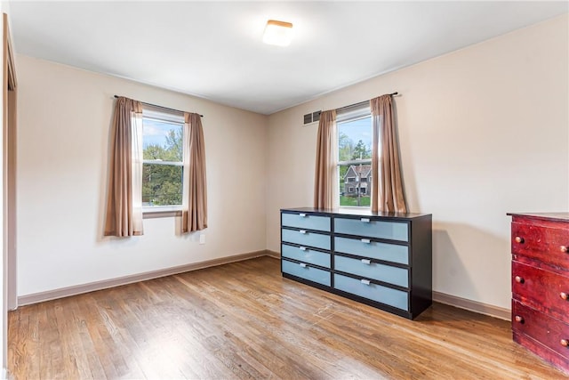 1900 Ardmore Blvd, Forest Hills Boro, PA 15221 - unfurnished bedroom with multiple windows, wood finished floors, and baseboards