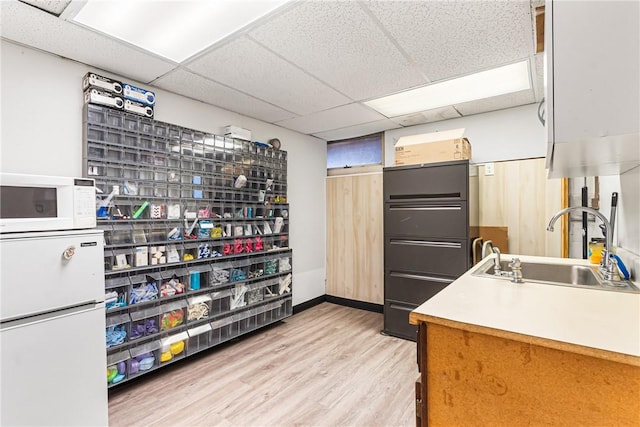 1900 Ardmore Blvd, Forest Hills Boro, PA 15221 - kitchen with a sink, light wood finished floors, white microwave, a paneled ceiling, and baseboards