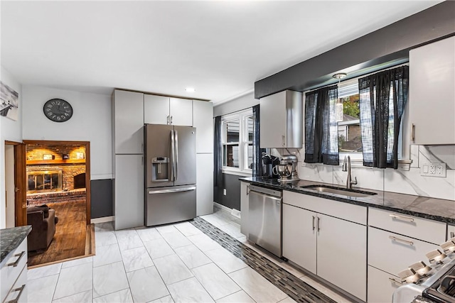 1900 Ardmore Blvd, Forest Hills Boro, PA 15221 - kitchen featuring stainless steel appliances, a sink, dark stone countertops, light marble finish floors, and recessed lighting
