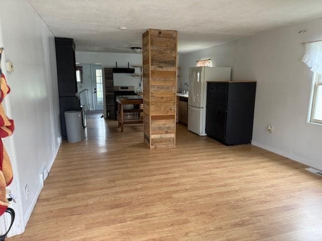 15 Miner Ave, Bentleyville, PA 15314 - unfurnished living room featuring light wood-type flooring, plenty of natural light, and baseboards