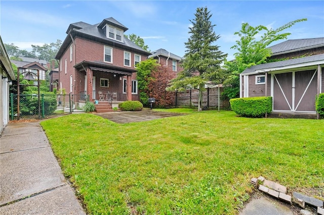 404 Lenox Ave, Forest Hills Boro, PA 15221 - back of house featuring brick siding, a gate, an outbuilding, and a patio