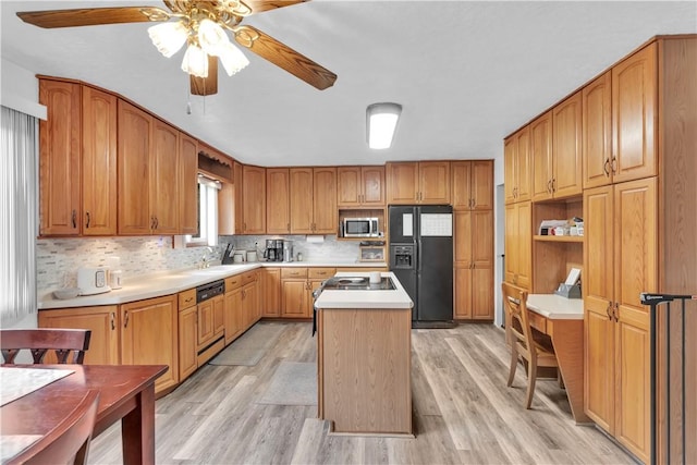 536 Hopewell Rd, Luzerne Twp, PA 15433 - kitchen with black fridge, stainless steel microwave, a kitchen island, light wood finished floors, and a ceiling fan