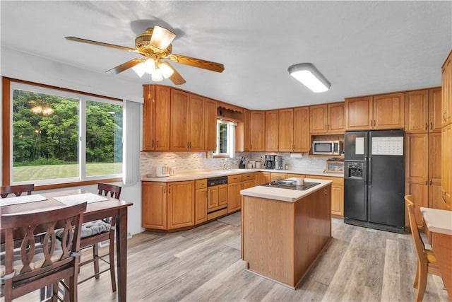 536 Hopewell Rd, Luzerne Twp, PA 15433 - kitchen featuring black fridge with ice dispenser, stainless steel microwave, dishwasher, light countertops, and electric cooktop
