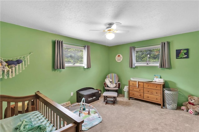 536 Hopewell Rd, Luzerne Twp, PA 15433 - bedroom featuring carpet, a nursery area, ceiling fan, and a textured ceiling