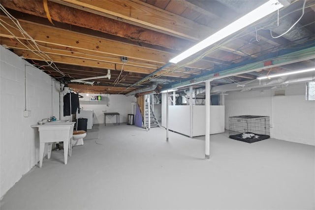 190 Elm St, Daugherty Twp, PA 15066 - unfinished below grade area featuring washer and dryer, stairs, and a sink