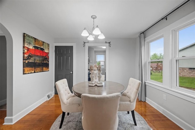 190 Elm St, Daugherty Twp, PA 15066 - dining area featuring arched walkways, wood finished floors, a chandelier, and baseboards