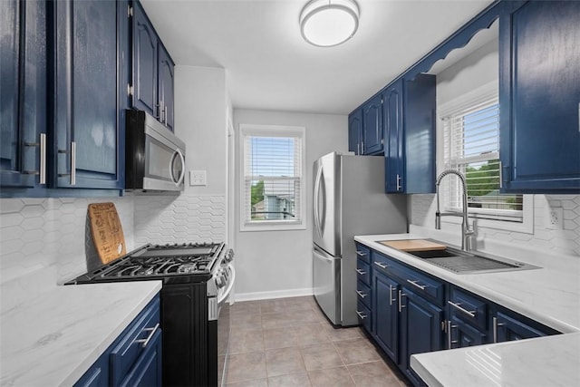 190 Elm St, Daugherty Twp, PA 15066 - kitchen with appliances with stainless steel finishes, blue cabinetry, plenty of natural light, and a sink