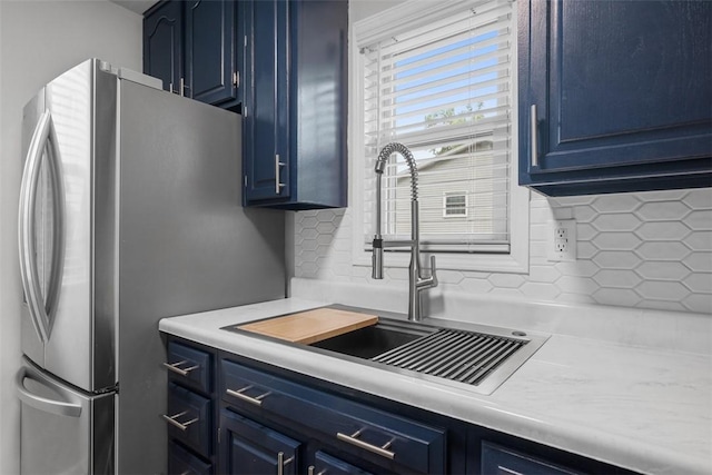 190 Elm St, Daugherty Twp, PA 15066 - kitchen with blue cabinets, freestanding refrigerator, a sink, backsplash, and light countertops