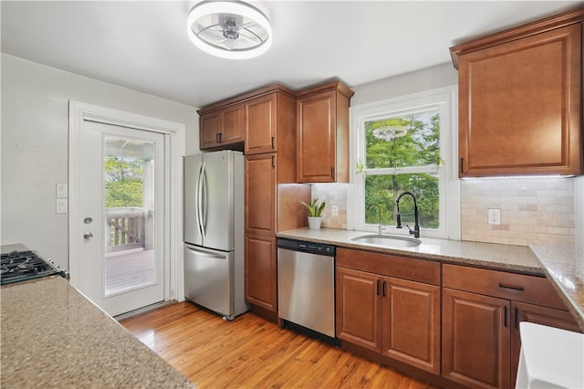 9440 Peebles Rd, Mccandless, PA 15101 - kitchen featuring stainless steel appliances, a sink, light wood-style floors, and tasteful backsplash
