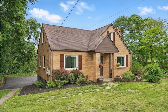 9440 Peebles Rd, Mccandless, PA 15101 - view of front of property with brick siding, a chimney, a front yard, and a shingled roof
