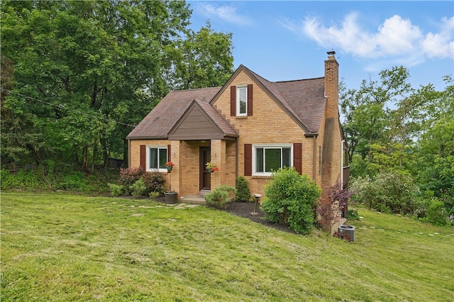 9440 Peebles Rd, Mccandless, PA 15101 - view of front of house featuring a front yard, a chimney, brick siding, and roof with shingles