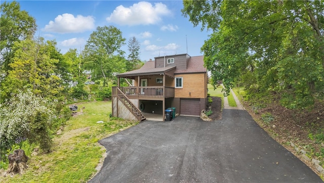 9440 Peebles Rd, Mccandless, PA 15101 - back of property featuring asphalt driveway, a garage, stairway, a porch, and a yard