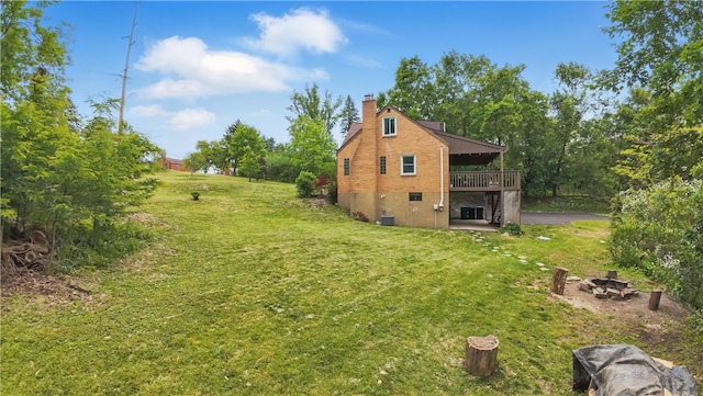 9440 Peebles Rd, Mccandless, PA 15101 - view of side of property with a lawn, a deck, a chimney, central AC, and an outdoor fire pit