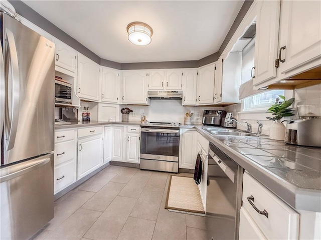 3181 Mellott Rd, Baldwin Boro, PA 15227 - kitchen with appliances with stainless steel finishes, under cabinet range hood, white cabinetry, and light tile patterned flooring