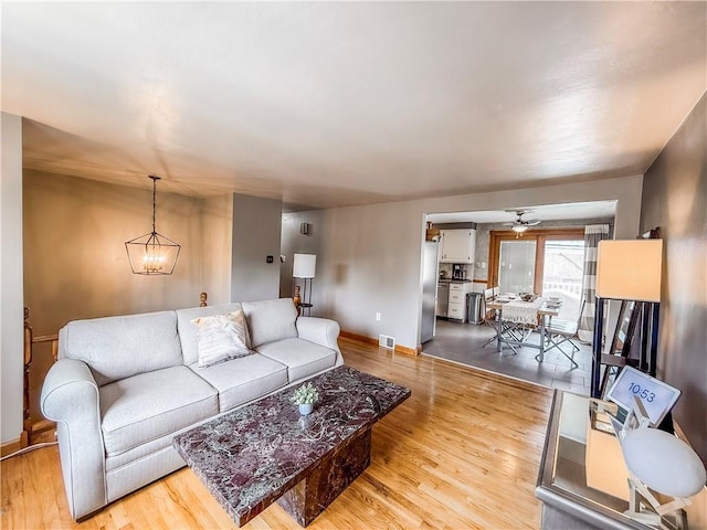 3181 Mellott Rd, Baldwin Boro, PA 15227 - living room featuring wood finished floors, baseboards, a chandelier, and a ceiling fan