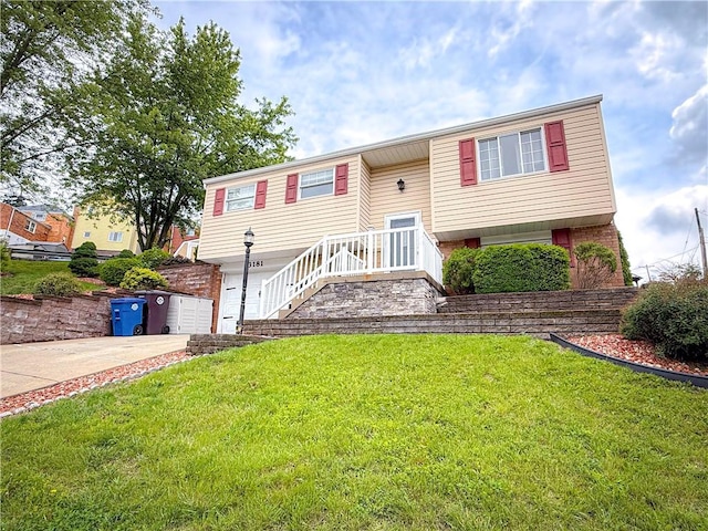 3181 Mellott Rd, Baldwin Boro, PA 15227 - split foyer home featuring concrete driveway, a front lawn, and a garage