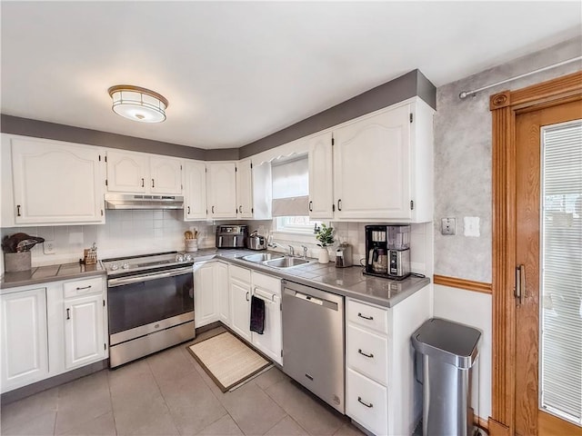 3181 Mellott Rd, Baldwin Boro, PA 15227 - kitchen featuring appliances with stainless steel finishes, under cabinet range hood, a sink, and white cabinetry