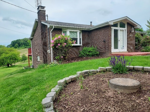 1046 Elicker Rd, Plum Boro, PA 15068 - view of front of home with brick siding, a front yard, and a chimney