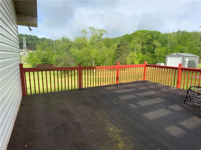 600 Moore Rd, South Franklin, PA 15301 - wooden terrace featuring a detached garage and a view of trees