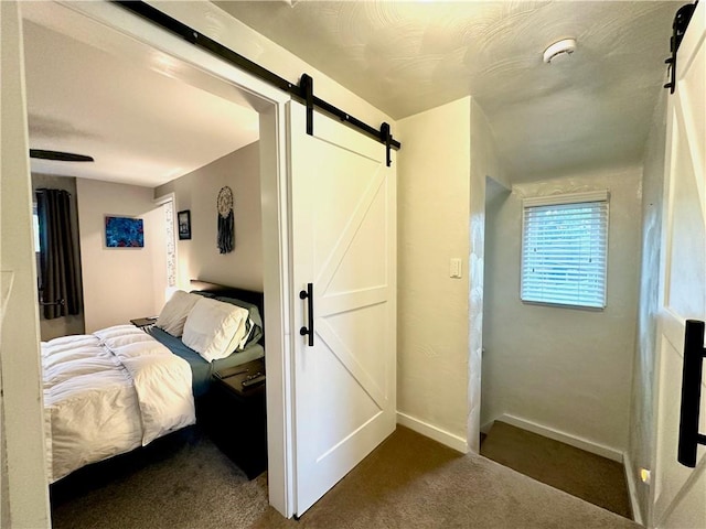 3301 Hazelhurst Ave, Baldwin Boro, PA 15227 - bedroom featuring a barn door, dark carpet, and baseboards