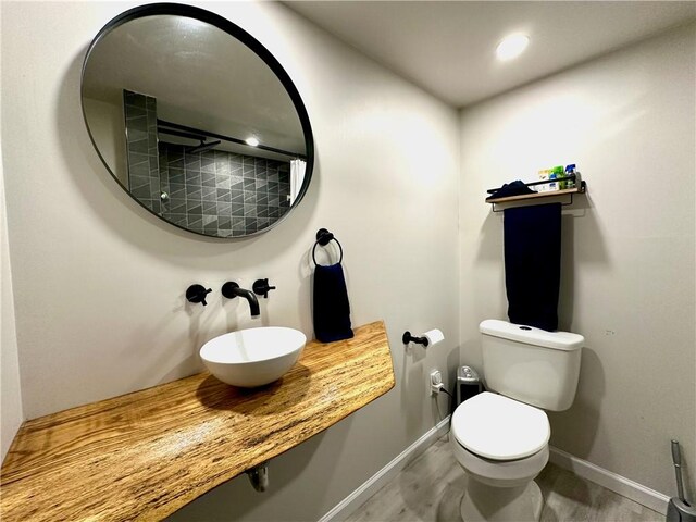 3301 Hazelhurst Ave, Baldwin Boro, PA 15227 - bathroom with a sink, baseboards, toilet, a shower with curtain, and wood finished floors