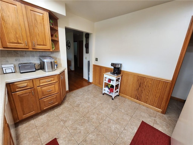 1013 Charles Dr, Union Twp Law, PA 16101 - kitchen featuring wainscoting, open shelves, brown cabinets, light countertops, and tasteful backsplash