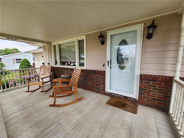 1013 Charles Dr, Union Twp Law, PA 16101 - doorway to property featuring covered porch and brick siding