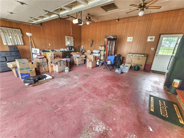 1013 Charles Dr, Union Twp Law, PA 16101 - garage featuring freestanding refrigerator, wood walls, a ceiling fan, and a garage door opener