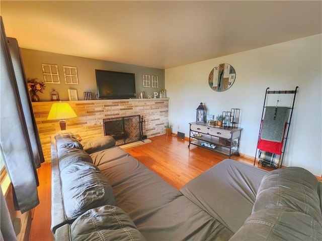 1013 Charles Dr, Union Twp Law, PA 16101 - living room with wood finished floors, a brick fireplace, and baseboards