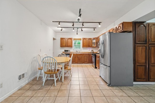 2883 Wilson St N, Franklin Twp, PA 15301 - kitchen featuring stainless steel appliances, track lighting, light tile patterned floors, and light countertops