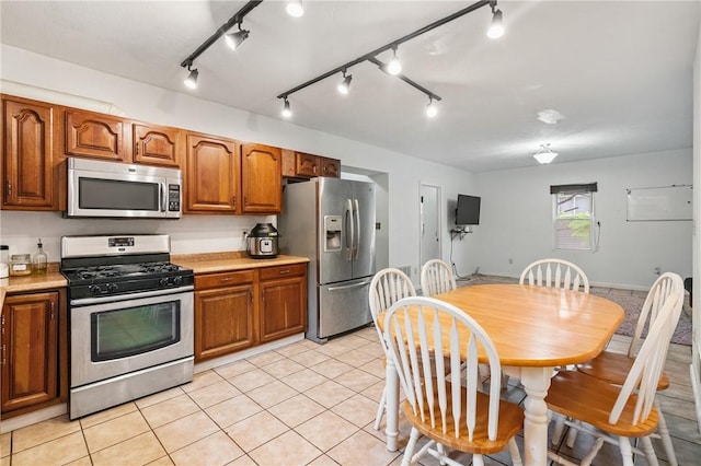 2883 Wilson St N, Franklin Twp, PA 15301 - kitchen featuring stainless steel appliances, light tile patterned floors, brown cabinets, light countertops, and track lighting