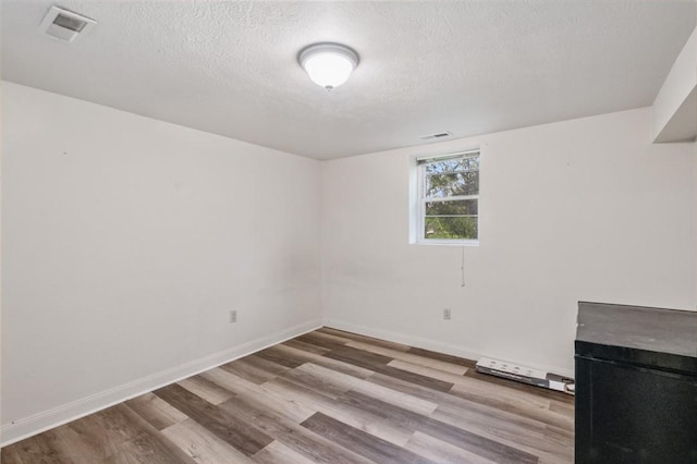 2883 Wilson St N, Franklin Twp, PA 15301 - spare room featuring wood finished floors, a textured ceiling, and baseboards
