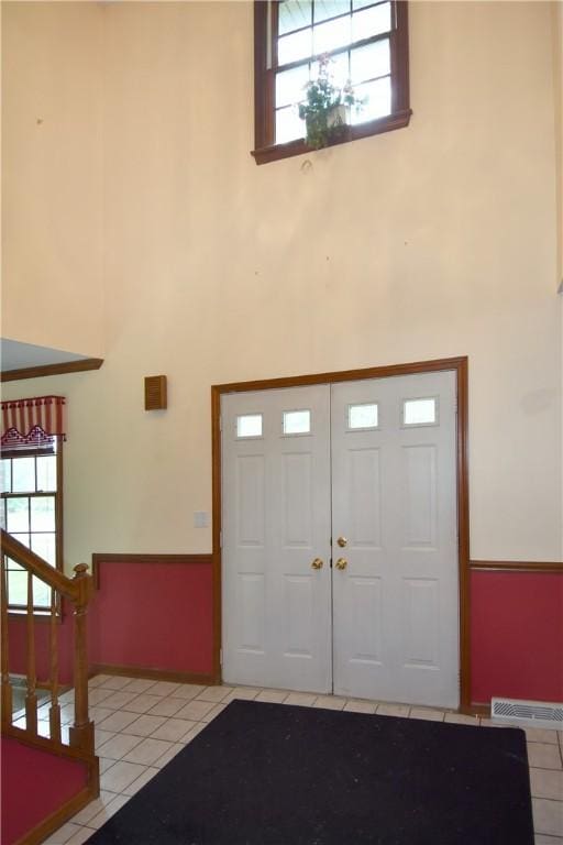 412 Forest Trails Dr, Mccandless, PA 15090 - entryway with a towering ceiling, light tile patterned flooring, stairs, plenty of natural light, and baseboards