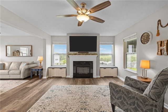 136 Azalea Cir, Belle Vernon Wml, PA 15012 - living room featuring a glass covered fireplace, ceiling fan, wood finished floors, and baseboards