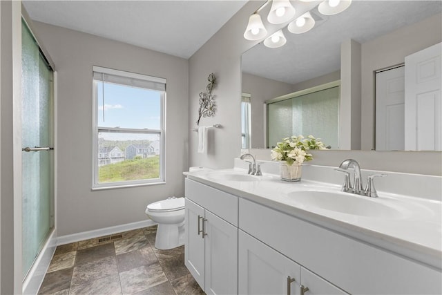136 Azalea Cir, Belle Vernon Wml, PA 15012 - bathroom with baseboards, toilet, a shower stall, double vanity, and stone finish floors