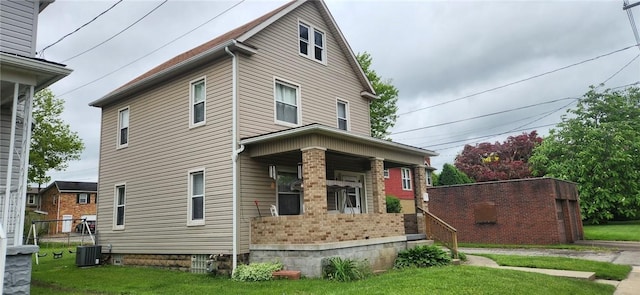 117 Glen Ave, Ellwood City Law, PA 16117 - view of home's exterior featuring covered porch, a lawn, and central AC