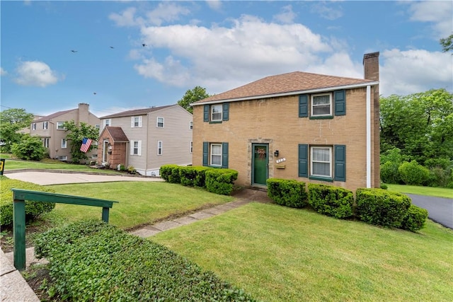 922 Bower Hill Rd, Mt Lebanon, PA 15243 - view of front facade with a chimney, a front yard, brick siding, and a residential view