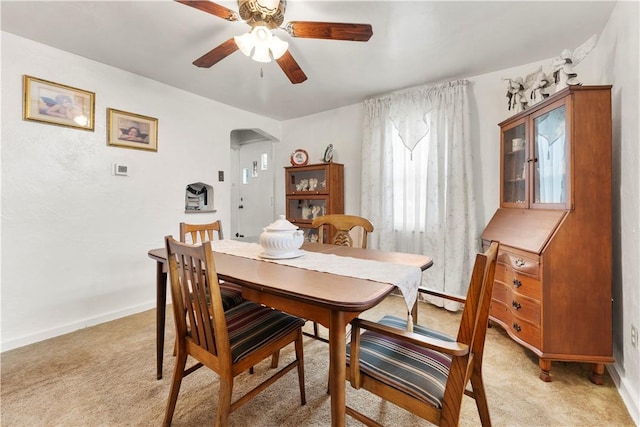 922 Bower Hill Rd, Mt Lebanon, PA 15243 - dining room featuring arched walkways, a ceiling fan, and light carpet