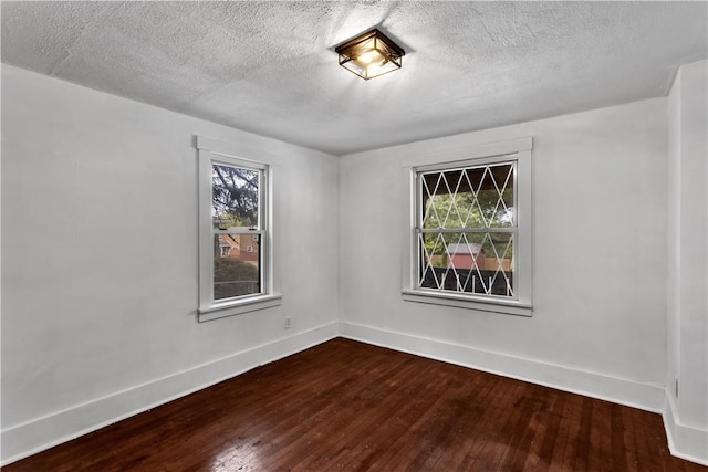 309 Delaware N, Versailles, PA 15137 - empty room with dark wood-type flooring, baseboards, and a textured ceiling