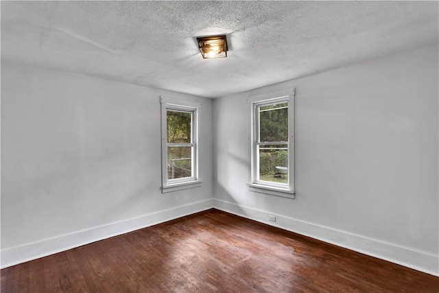 309 Delaware N, Versailles, PA 15137 - spare room with baseboards, dark wood-style floors, and a textured ceiling
