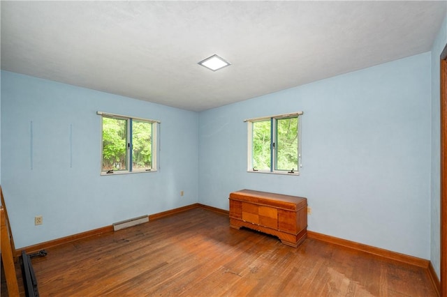541 W Danville Rd, Oakland Twp, PA 16025 - empty room with baseboard heating, plenty of natural light, wood finished floors, and baseboards
