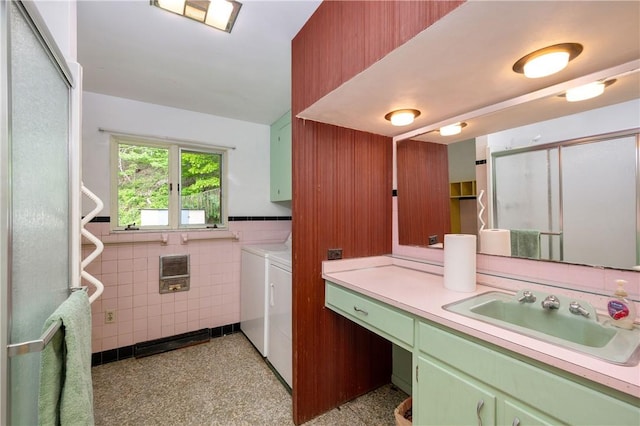 541 W Danville Rd, Oakland Twp, PA 16025 - washroom with washer and dryer, cabinet space, tile walls, heating unit, and a wainscoted wall