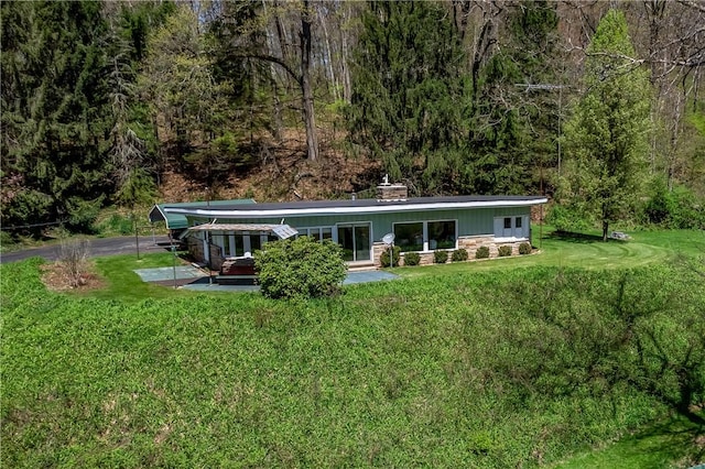 541 W Danville Rd, Oakland Twp, PA 16025 - back of house featuring a lawn, a wooded view, and stone siding
