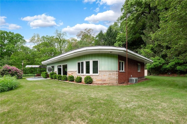 541 W Danville Rd, Oakland Twp, PA 16025 - view of property exterior with a lawn, stone siding, cooling unit, and board and batten siding
