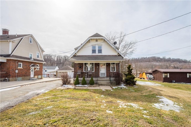 2489 Jefferson Ave, Canton Twp, PA 15301 - bungalow featuring a porch, an outbuilding, brick siding, and a front yard