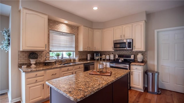 104 Cherokee Ct, Buffalo Twp But, PA 16229 - kitchen featuring appliances with stainless steel finishes, light stone counters, wood finished floors, backsplash, and recessed lighting