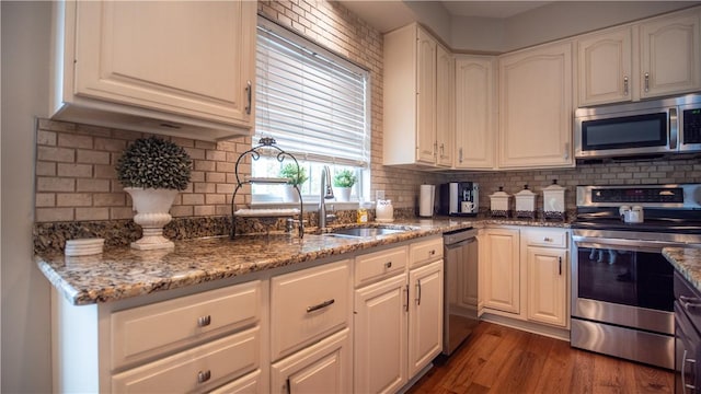 104 Cherokee Ct, Buffalo Twp But, PA 16229 - kitchen featuring appliances with stainless steel finishes, a sink, decorative backsplash, and stone countertops